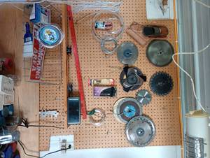lot 870 image: Peg Board w Circle Saw Blades, Signs, Contents