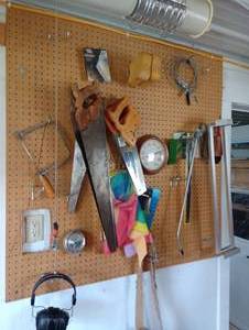 lot 918 image: Pegboard w Contents- Hand Saws, Belt, Ear Muffs, Etc