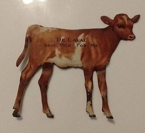 lot 943 image: Small Metal Vintage Advertising Cow