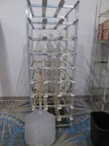 lot 200 image: NSF bakers rack with pizza spatula by New Age industrial Corp. stands 70 tall 34 deep and 25 wide