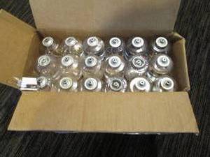 lot 227 image: Box of 36 oil lamps made of plastic, partially filled with oil