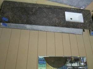 lot 359 image: Granite countertop with sink, measures 80.5 x 22. one edge is missing about an inch due to wall cutout