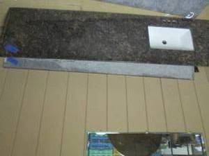lot 360 image: Granite countertop with sink, measures 80.5 x 22. one edge is missing about an inch due to wall cutout