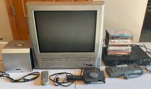 lot 293 image: MAIN - Home Entertainment Lot Magnavox TVDVDVCR Combo, Dell Subwoofer, Motorola Receiver, and DVD Collection - untested