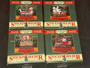 lot 167 image: BASEMENT - Coca-Cola North Pole Bottling Works Express Stocking Holder Collection - Set of 4