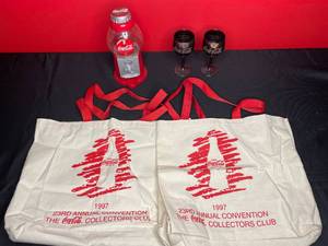 lot 467 image: BASEMENT - Coca-Cola Collectors Club Memorabilia Lot - Bags, Dispenser, and Glasses