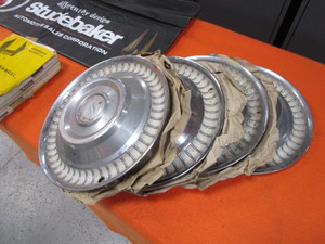 lot 6-B image: Studebaker Manual, Hubcaps, Fender Protector