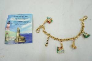 lot 65 image: TK signed lighthouse bracelet, and pin