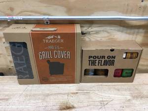 lot 91 image: Traeger grill cover and set of BBQ sauces and seasonings