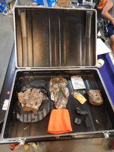 lot 17 image: Large hard case with assorted hunting supplies