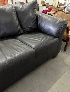 lot 12 image: Bold Black Faux Leather Sofa  Couch