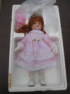 lot 46 image: Porcelain doll with auburn hair, gr...