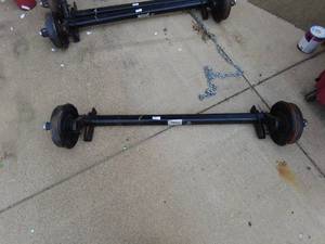 lot 303 image: New Lippert Trailer Axle Assembly. Electric Brake drums.  4500# capacity