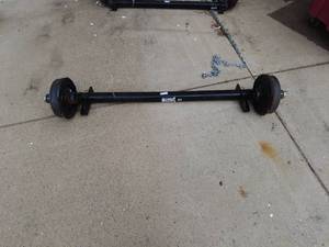 lot 304 image: New Lippert Trailer axle with electric brake drums. 4500# capacity