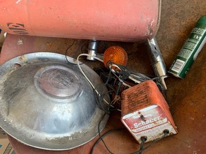 Wheelbarrow, gas can and hubcap