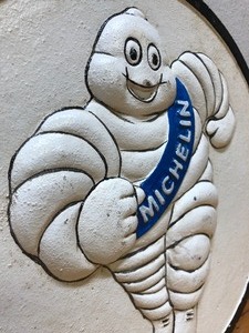 lot 194 image: Pair of Vintage Embossed Cast Iron MICHELIN MAN Round Advertising SignsPlaques