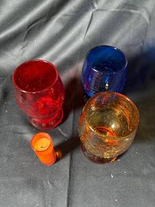 lot 705 image: Lot of 4 Assorted Color Votive Holders and Candle