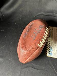 lot 751 image: Assorted Lot Wilson Football, Floral Planner, Box of White Stones