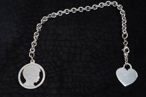 lot 286 image: Sterling Silver Charm Bracelet with Heart Charm
