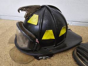 Used firemans helmet and a pair of used firemans boots - size 8