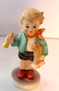 lot 186 image: Hummel Boy with Toy Horn and Horse Figurine, Coaster Set and Round Plaque