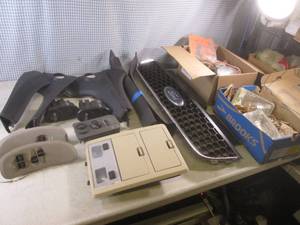 lot 43 image: (BR3) Assorted Interior Car Parts, Ford Grill, Headlights and Box of Honda CR Motorcycle Parts