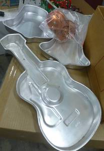 lot 273 image: Guitar cake pan, bells, frosting shooter, and box full of cake decoration items