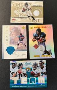 lot 65B image: Jacksonville Jaguars 4 Card Relic Lot - Team Quad Relic 99, Mark Brunnell, Keenan McCardell, Fred Taylor Football Cards