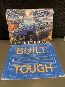 lot 87 image: Set of 2 Metal Ford Truck Signs - Driven by Freedom and Built Tough