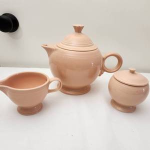 lot 60 image: Vintage Apricot Fiesta Ware Sugar and Creamer and Pitcher Teapot