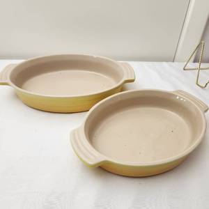 lot 82 image: Two Le Creuset Stoneware Baking Dishes in Yellow, Like New Condition