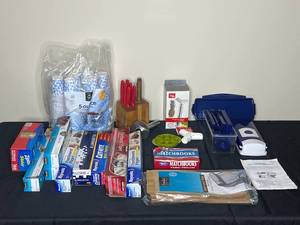 lot 74 image: Multi-Purpose Chopper, Matchbooks, 2 Incomplete Knife Sets, Pineapple Core Tool, Small Disposable Cups, Variety of Parchment Paper, Aluminum Foil, etc.