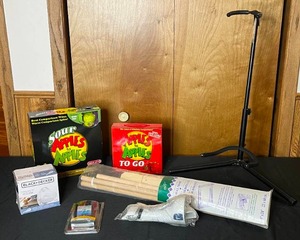 lot 175 image: 2 Apples to Apples Games, Guitar Stand, Needlework Scroll Frame, Black  Decker Replacement Filter, etc.