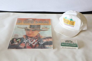 lot 564 image: Memorabilia 90s K102 Tanya Tucker Autographed Hot Country Headlines Magazine Cover, Hat and Cassette Tape