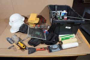 lot 255 image: Bin Full of Assorted Tools -Hard Hats, Painting Materials, Hand Shovels