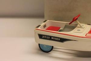 lot 7 image: Vintage Jolly Roger Tin Toy Boat with Box