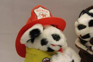 lot 84 image: Texaco Dalmatian Plush Toy Set - Firefighter and Pilot Outfits