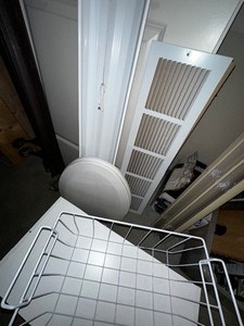 lot 295 image: Various Home Improvement Items - Toilet Seat Cover, Vent Cover, Shoe Storage, Metal Basket and Shop Light