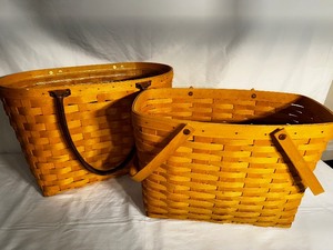 lot 201 image: Two Large Longaberger Baskets. One with leather handles and one with wood handles.  Measuring 18x10x12 and 16x9x11