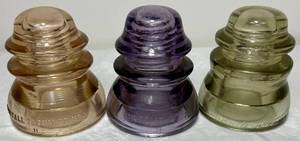 lot 75 image: Set of 3 Antique Insulators- Purple Whitehall Tatum Co No.1, Clear Whitehall Tatum Co. No. 1, Clear Armstrongs