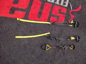 lot 83 image: TRX Suspension trainer straps with adjustable foot cradles, and extenders