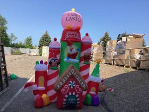 lot 410 image: 10FT Lighted Giant Inflatable Christmas Castle- Christmas Inflatables Santas House, Castle Candy Santa Reindeer Gingerbread Penguin for Christmas