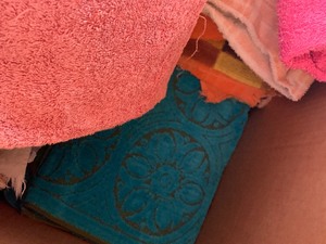 Box of towels, pillows, coffee pot and dishes