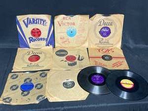 lot 25 image: Lot of 45s - Woody Woodpecker and the Scarecrow, Arthur Fields Aint She Sweet, Yogi Yorgesson Yingle Bells, Arther Godfrey Im Looking for a Four Leaf Clover, Arizona Cliff Martin Music Hall Orchestra Frosty the Snowman and More