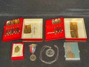 lot 108 image: 1953 Queen Elizabeth II Coronation Medal, Decorative QEII Stamped Pendant, Chicago Pendant and Bronze Miniature Spoons from S. Samran Thailand Co., LTD - Made in Thailand