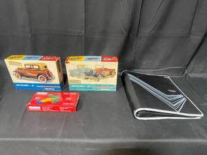 lot 143 image: Hubley Metal Kit Model A Victoria  Metal Kit Model A Pickup Truck  Five Star Notebook Protector  Biplane Kit