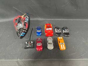 lot 198 image: Remote Control Boat (untested) & Assortment of Play Race Cars