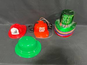 lot 234 image: Assortment of NYE Hats & Holiday Hats Inc Irish, Fireman & Thinking Cap Beverage Holder Hat
