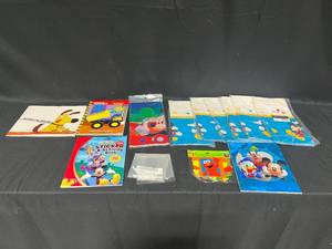 lot 238 image: 7 Disney Disposable Tablecloths, Elmo Happy Birthday Banner, Sticker Book, Disney Sketch Pad, Tonka Coloring Book, Always in Trouble Scholastic Book