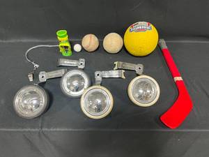lot 255 image: Lot of Sporting Equipment Inc Golf Tees, Balls, Plastic Hockey Stick and 2 Sets of Training Wheels